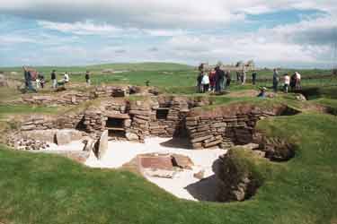 Skara Brae. House 8 with Skaill House in the distance