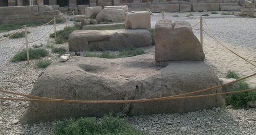 Granite thresholds of the Middle Kingdom Temple with the calcite pedestal at the rear (© UCLA Owned)